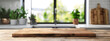 © sanjit536 - Empty wooden board on a table with a blurred background of a modern kitchen interior