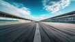 © zipop - Empty asphalt racing track road with tire marks on a sunny day. Concept of speed, competition, motorsport, and racing.