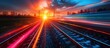 © MBRAMO - Train Tracks at Sunset With Blurred Light Trails