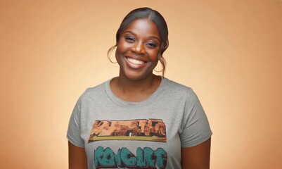 Canvas Print - Portrait of a beautiful young african american woman smiling over orange background