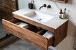 © Kevin - a bathroom sink with a wooden cabinet underneath it