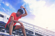 © Panumas - Tired runner man with a bottle of water pouring to himself for freshness after training outdoor workout at the stadium stairway.