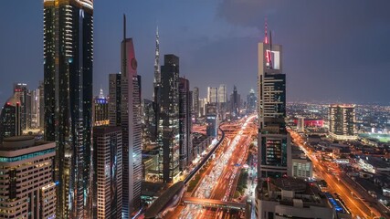 Wall Mural - Dusk to night timelapse view of traffic and skyscrapers along Sheikh Zayed Road in Dubai, United Arab Emirates (UAE), zoom in. 