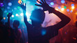 © VK Studio - An individual dances joyfully with arms reaching towards the lights, lost in the rhythm and energy of a vividly lit dance floor.