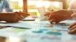© AhmadTriwahyuutomo - Closeup of Business Meeting Table with Documents and Graphs in Bright Daylight Office