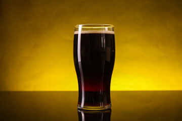 Wall Mural - Glass of beer with froth on dark table, closeup