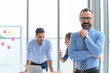 © bigy9950 - Successful businessman owner with arms crossed standing with teams meeting on background in the office.