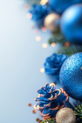 Wall Mural - blue christmas decorations with glittering ornaments and pine cones on a light blue background. perf
