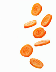 Wall Mural - Fresh carrot slices falling on a white background in high resolution