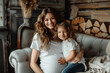 © Robert Kneschke - Portrait of a happy pregnant woman and her daughter sitting on a sofa in a cozy home setting