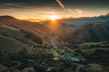 Wall Mural - Sunrise over Arves massif among French Alps with ski town in valley during autumn