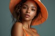 © Magiurg - Woman in Orange Bikini with Hat.A mesmerizing woman in an orange bikini and matching hat poses gracefully, capturing the essence of summer with a soft, warm background.