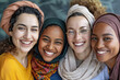 © shobakhul - Four women wearing scarves and smiling for the camera.