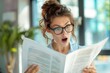 © Igor - Shocked young business woman reading a document office bright blurred background