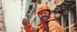 © VarunyuAi - A happy construction worker in an orange safety suit giving a thumbs up on a job site, showcasing enthusiasm and dedication.