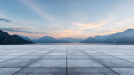 Wall Mural - Empty square tile floor with mountain landscape background at sunset. Abstract panoramic view of empty concrete surface with sky and clouds in the distance. Background for product display,