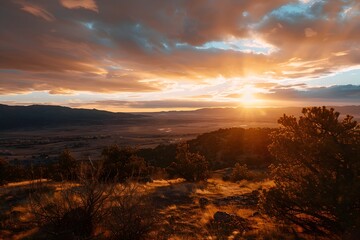 Wall Mural - Breathtaking sunset over rolling hills and valleys, casting golden hues across the sky.