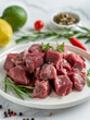 © si9nzation - Fresh raw beef meat chopped in cubes on plate for cooking stew or meat dish
