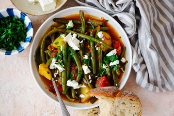 Poster - Fasolakia. Greek stew of green beans and feta vegetables on a plate with ..top veiw.selective focus