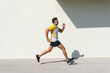 © ADDICTIVE STOCK - Indian man running during summer sports training