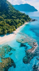 A beautiful blue ocean with a sandy beach and a mountain in the background