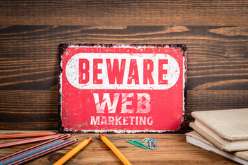 Wall Mural - Web Marketing. Beware sign with text on a wooden texture office table