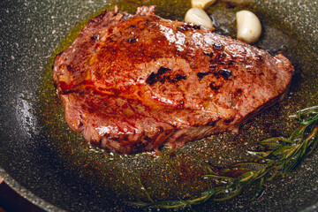 fried steak, beef steak, rib eye steak, in a frying pan, top view, no people