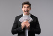 © kohanova1991 - Happy excited businessman with cash money - USD currency dollars banknotes on grey wall. Symbol of jackpot, gain, victory, winning