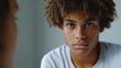 © Iuliia Metkalova - Pensive Multiracial Teen with Curly Hair in Thoughtful Moment for Youthful Reflection Themes. Generative ai