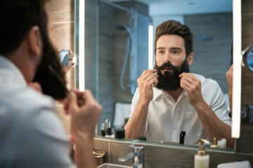 A man in white shirt brushing his beard while looking into the mirror, AI