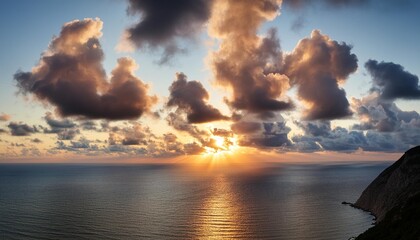 Wall Mural - cold dawn of the sun in the clouds in the sky over the sea for wallpaper