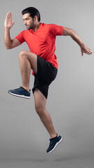 Full body length gaiety shot athletic and sporty young man fitness running cardio exercise posture on isolated background. Healthy active and body care lifestyle.