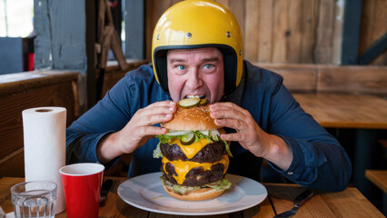 Wall Mural - A man in a helmet eating a large cheeseburger, AI