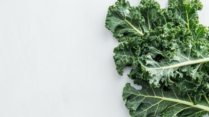 Kale leaves from above on white surface with space for text