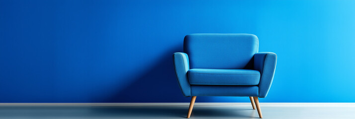 Poster - Modern blue armchair standing in empty room with blue wall