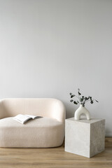 Sticker - White couch and side table with vase and book in room