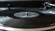 © Tati - Spinning black vinyl record on turntable, close-up of needle and grooves