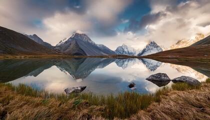 Canvas Print - beautiful photo of the mountains reflecting in the cold lake under the cloudy sky generative ia