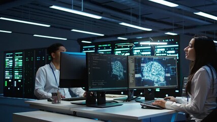 Wall Mural - Team of engineers using AI tech on computer to do checkup in server room. Data center workers using artificial intelligence technology to process datasets for training, camera B