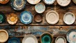 © AkuAku - Overhead view of vintage style ceramic plates on wooden surface