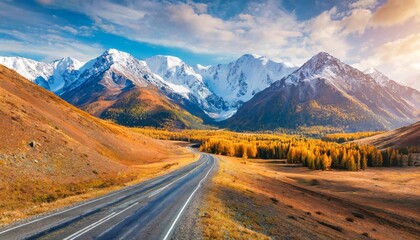 Beautiful road in autumn mountains. Chuysky tract and view of North-Chuya mountain ridge in Altai, Siberia, Russia. Autumn landscape at sunset