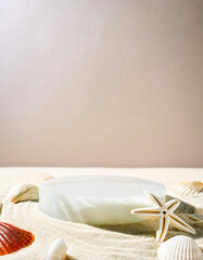 Canvas Print - Seashell and Starfish on Sand with White Podium