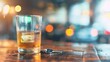 © red_orange_stock - A whiskey glass sits next to car keys on a bar table, illuminated by soft ambient lighting in a lively atmosphere