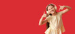 © Pixel-Shot - Little girl in headphones pointing at herself on red background