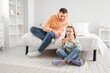 © Pixel-Shot - Father and his daughter watching something on smartphone in bedroom
