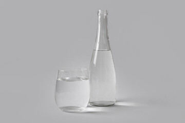 Wall Mural - Bottle of clean water and glass on white background