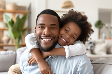 Happy african american father and daughter embracing at home