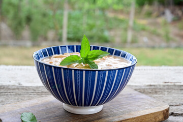   Homemade bean soup .Steamed white beans in tomato sauce  on a wooden background  