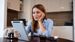© PeopleVideos - Happy woman using tablet at home
