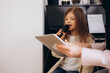 © Roman - A female teacher teaches a little girl to sing at a music school